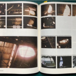 Photo of an open book or magazine. Indistinct images are featured on the pages.