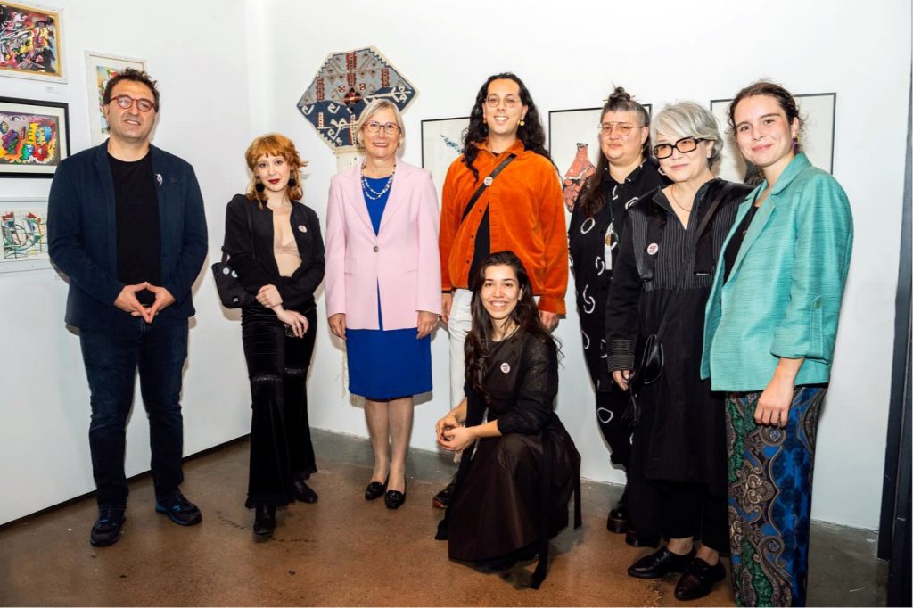 A group photo of Serkan Taycan with participating artists and Turkish ambassador to Canada, Esra Demir at the exhibition