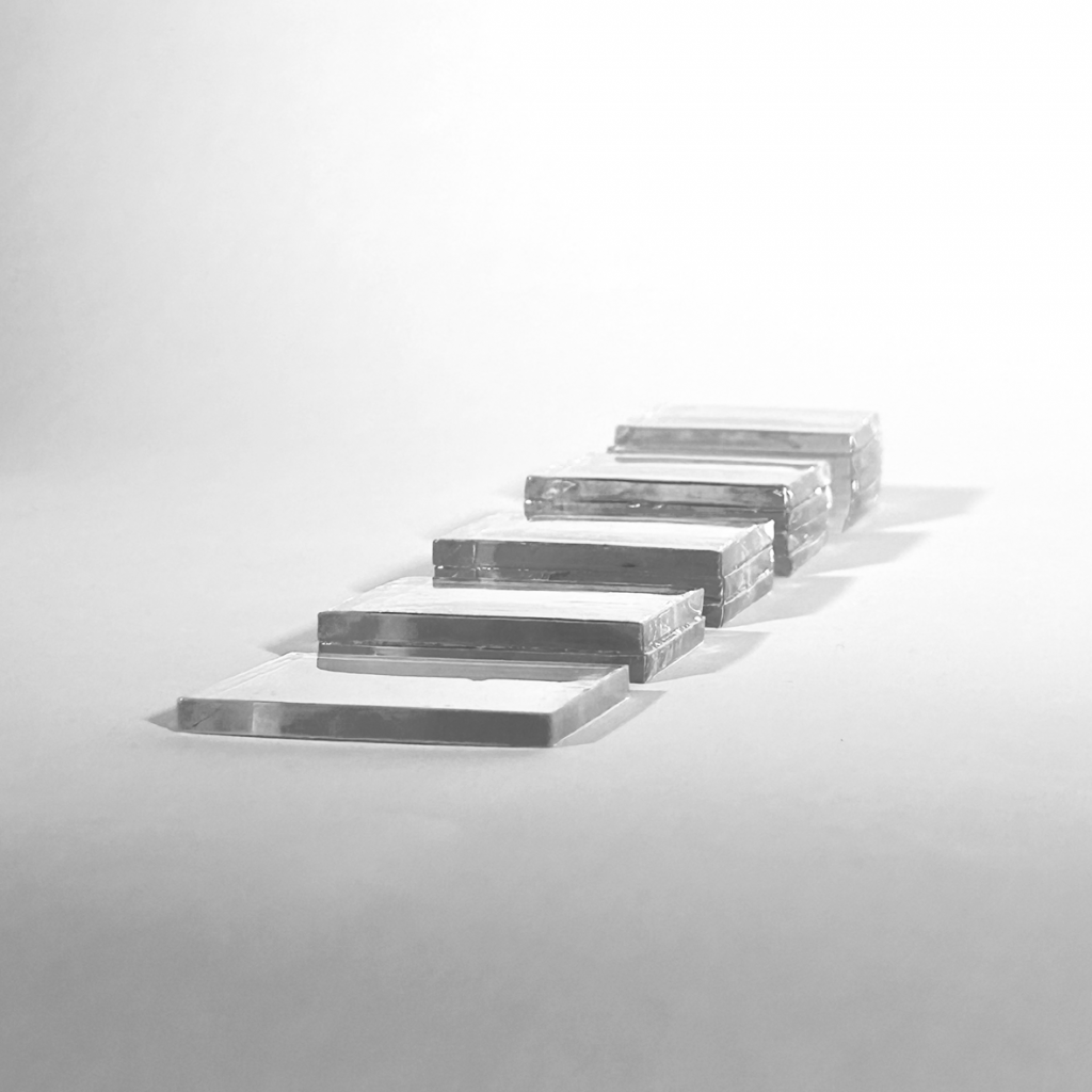 a black and white photograph showing a series of rectangular glass blocks arranged in a staggered, ascending pattern