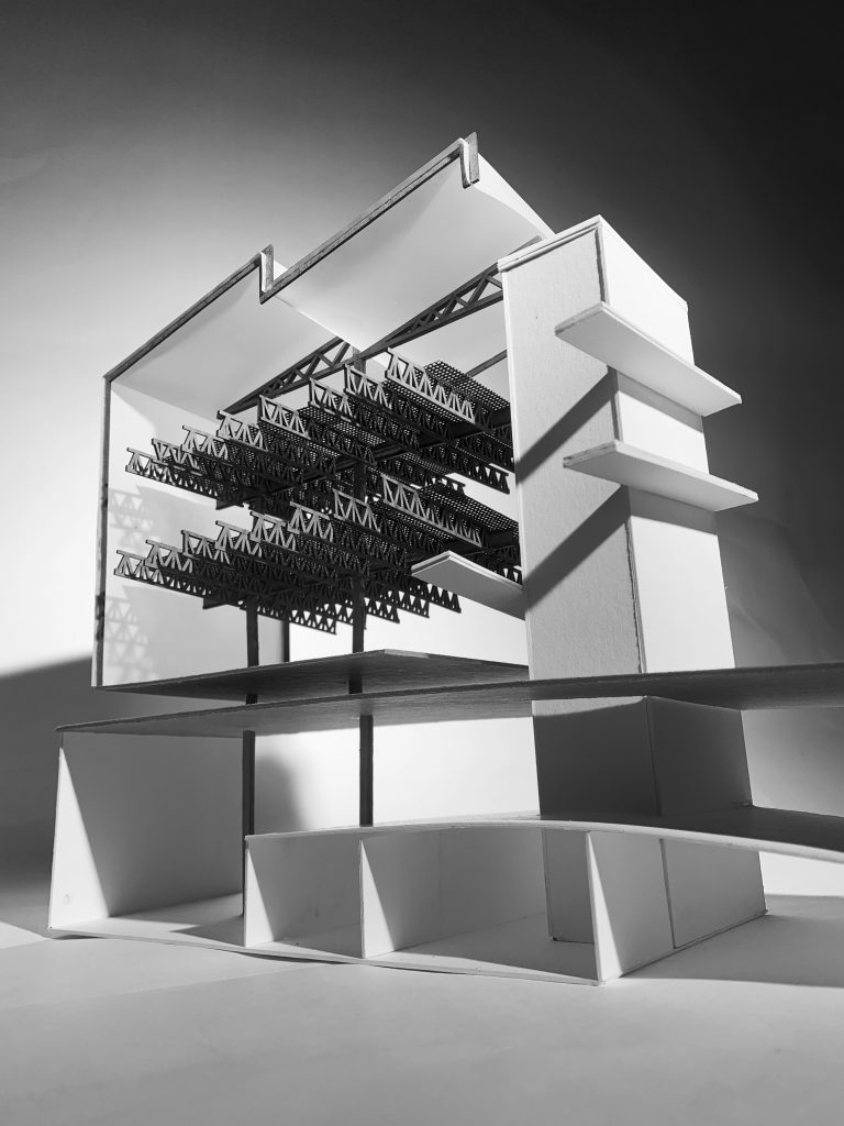 Black and white photo of a detailed architectural model with intricate structural elements and multi-level design.