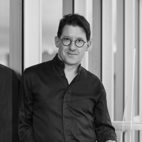 Black and white headshot of Paul Kariouk