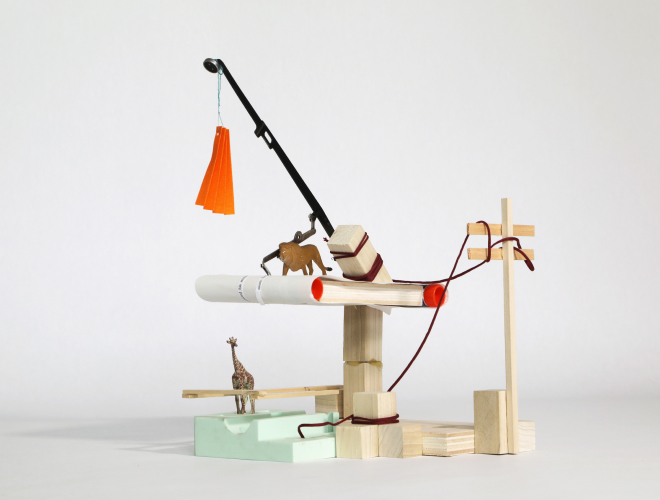 A model constructed from wood, featuring animal figurines and a black rod holding an orange tassel.