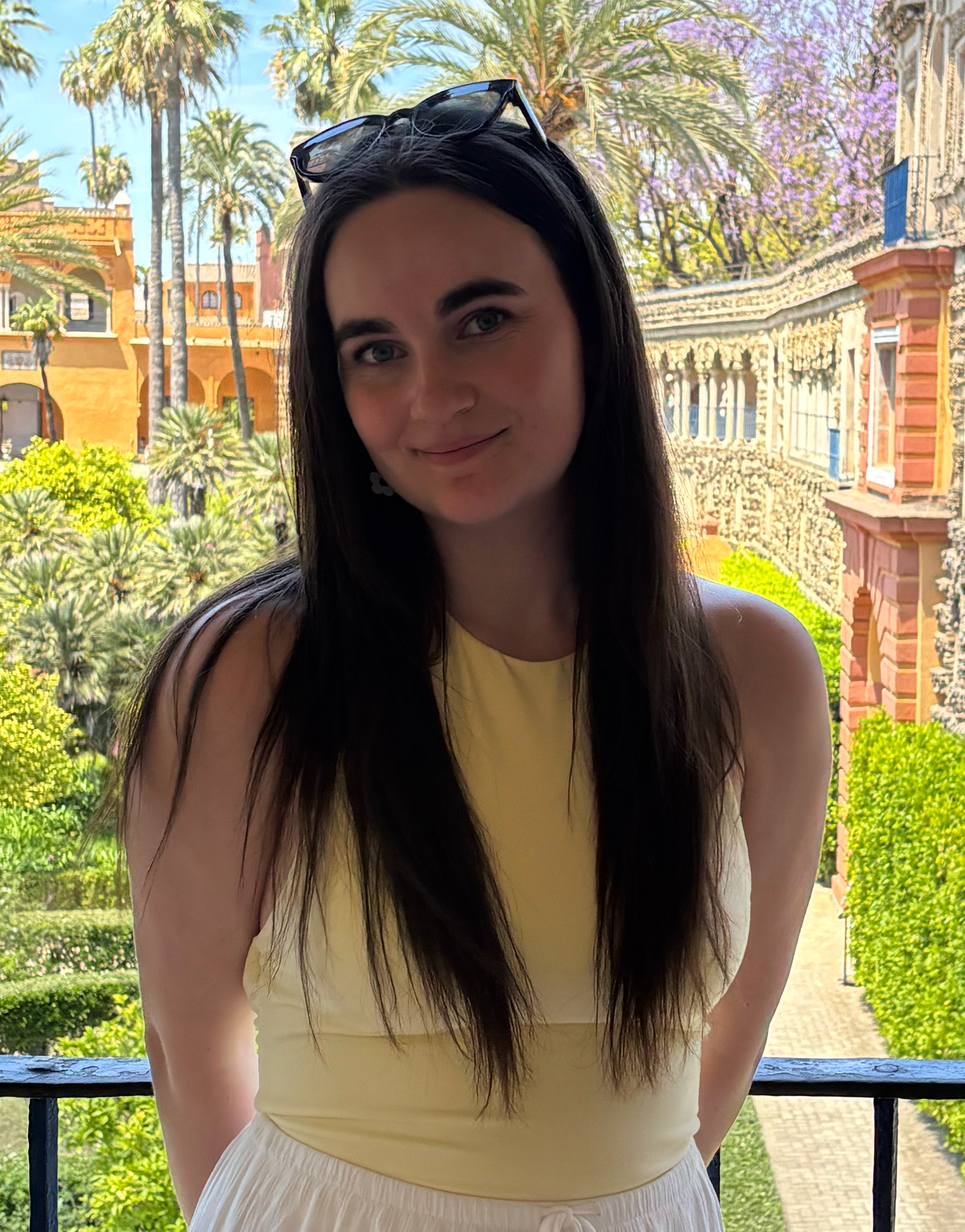 a picture of Natalie, next to a courtyard.