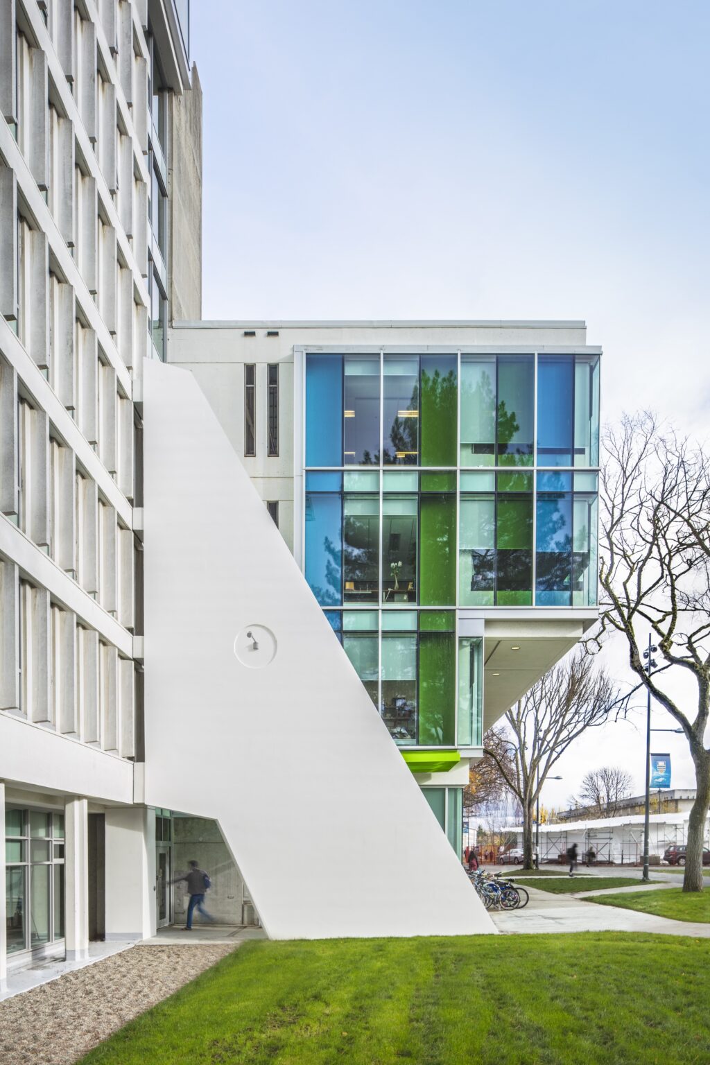 UBC Sauder School of Business building with a white seismic buttress and colorful glass facade.