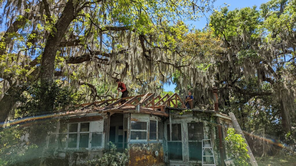 Workers carefully dismantle a historic cottage as part of Re:Purpose Savannah’s building material reuse initiative.