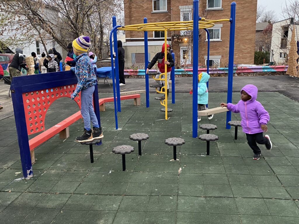 Children playing on the climbing and balancing equipment in the HUB’s outdoor play area.