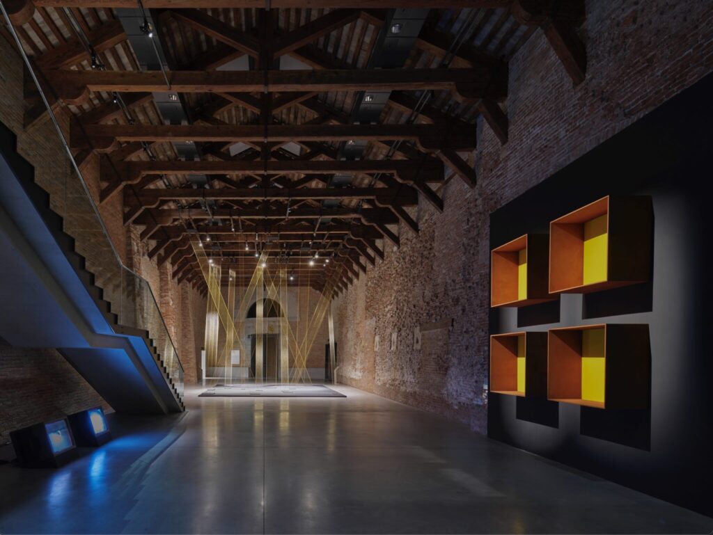 Large interior space with exposed brick walls, timber roof structure, and contemporary insertions.