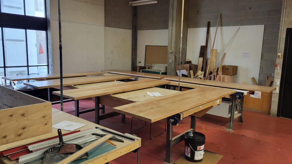 Wood on the workspaces in the woodshop.