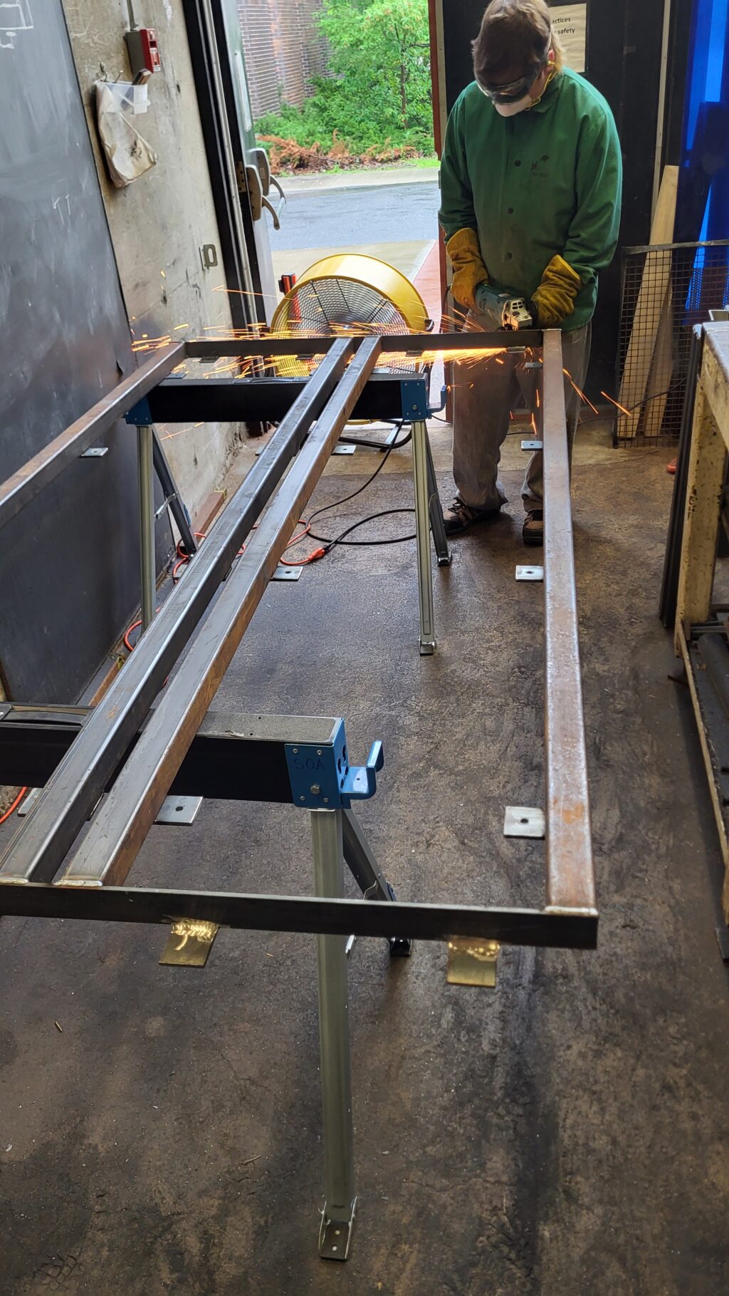 Noah Perkins holding a welding tool.